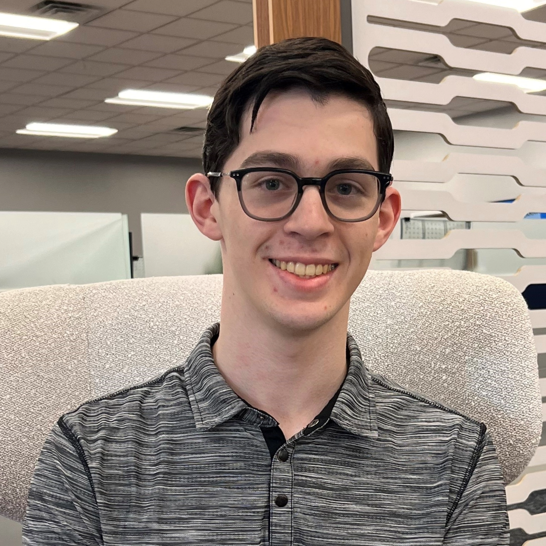 A person sitting in a chairDescription automatically generated